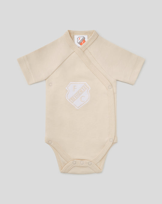 Beige baby romper with cross wrap front and FC Utrecht shield logo