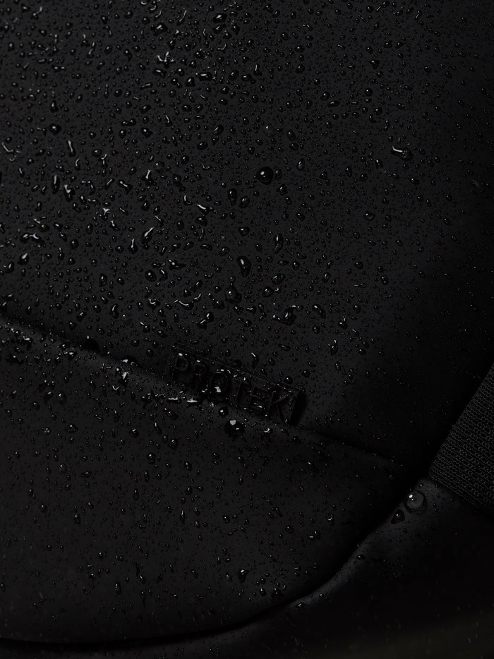 Close up of water droplets on black Castore Core Backpack fabric