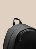 Castore Core Backpack Gunmetal partial top view with sturdy strap handle on beige backdrop