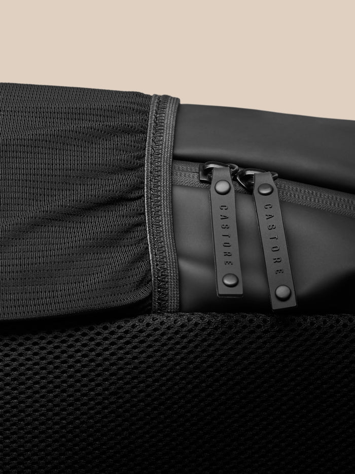 Close up of midnight blue Core Backpack fabric and zipper with stitching detail