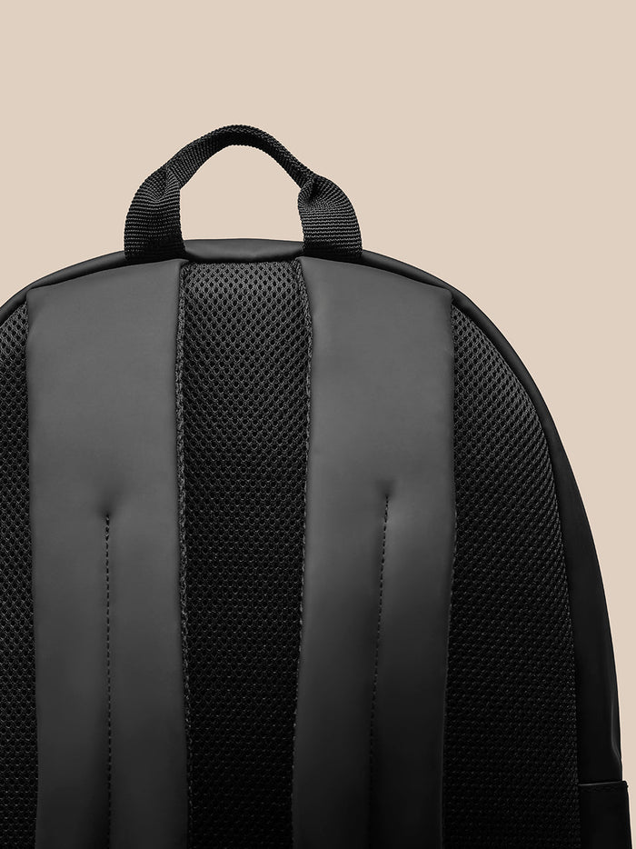 Top section of Core Backpack midnight navy with sturdy grab handle and padded back panel.