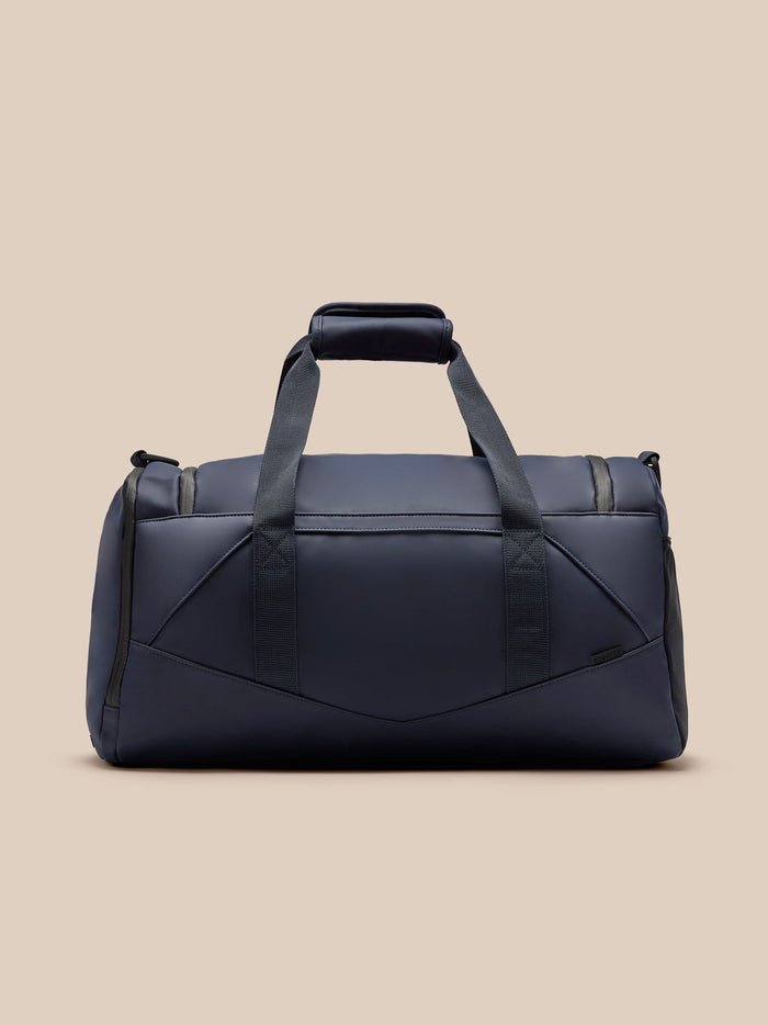 Midnight navy Core Holdall with padded handles and adjustable shoulder strap viewed from a front angle