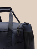 Close up of navy Core Holdall zipper area with two zipper pulls and mesh side pocket