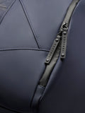 Close-up of navy Core Holdall zipper area with dual pulls bearing CASTORE on dark PU fabric.