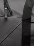 Close up of zipper pulls and strap on a gunmetal Core Holdall bag