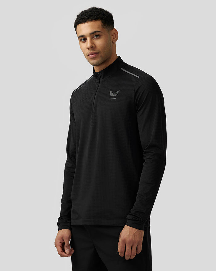 Male model wearing black Apex Aeromesh Kwartrits Top with funnel neck and reflective left chest logo