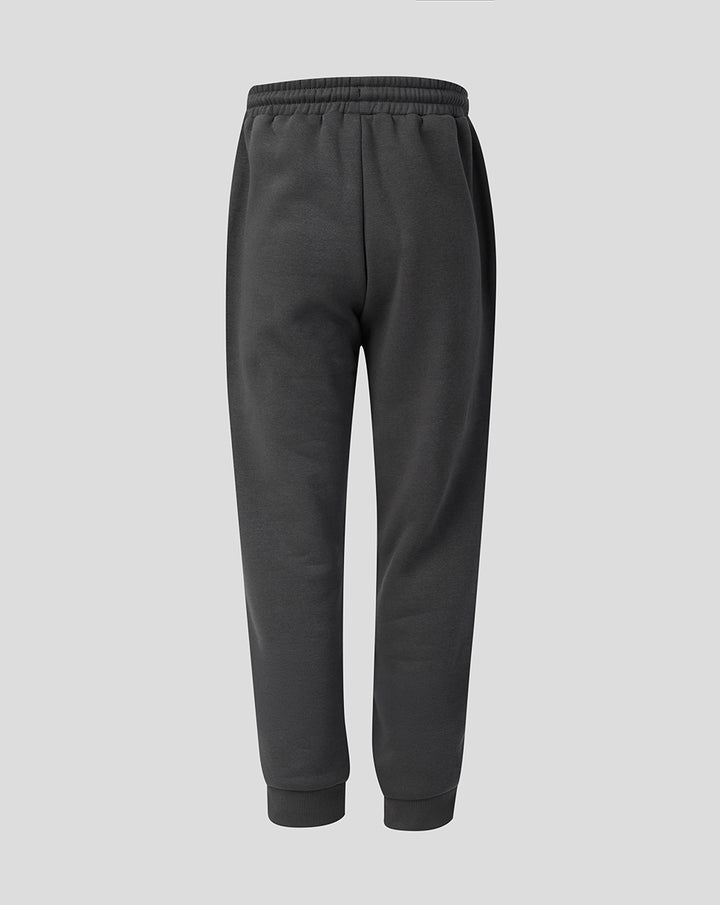 Side view of junior FC Utrecht Travel fleece joggers in dark grey with a crest patch on the leg.