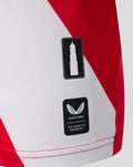 Lower portion of FC Utrecht home shirt featuring diagonal white panel and two badges a tower icon and Castore authentic product label
