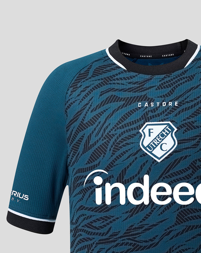 Close up of the FC Utrecht 26/27 junior away shirt chest with tiger stripe motif crest and sponsor logo.