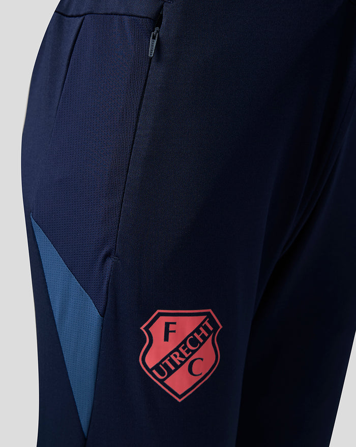 Side view of navy training pants with zip pocket and pink FC Utrecht crest