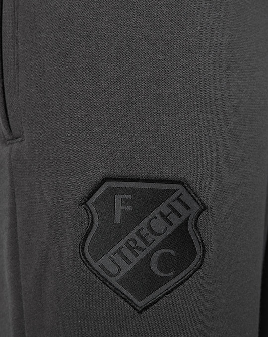 Close-up of FC Utrecht crest patch on dark grey fleece shorts