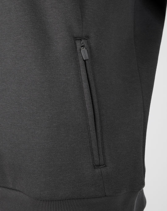 Close-up of a zippered side pocket on the dark grey FC Utrecht Travel hoodie.