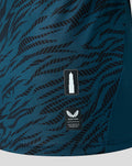 Close up of teal tiger pattern on FC Utrecht shirt with a tower badge and authentic product label.
