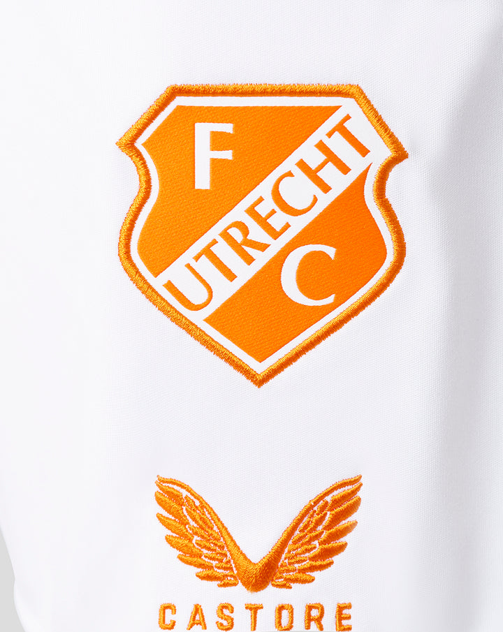 Close up of FC Utrecht crest patch on white fabric with an orange shield and diagonal UTRECHT lettering.