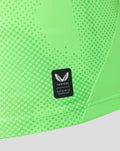 Detail of neon green FC Utrecht goalkeeper shirt with dotted texture and authentic Castore product badge