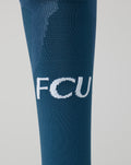 Close up of blue FC Utrecht junior sock showing white FCU initials on the shin