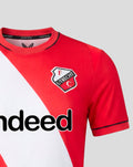 Close-up of FC Utrecht home shirt 26/27 for women showing red fabric with a diagonal white sash and the club crest.