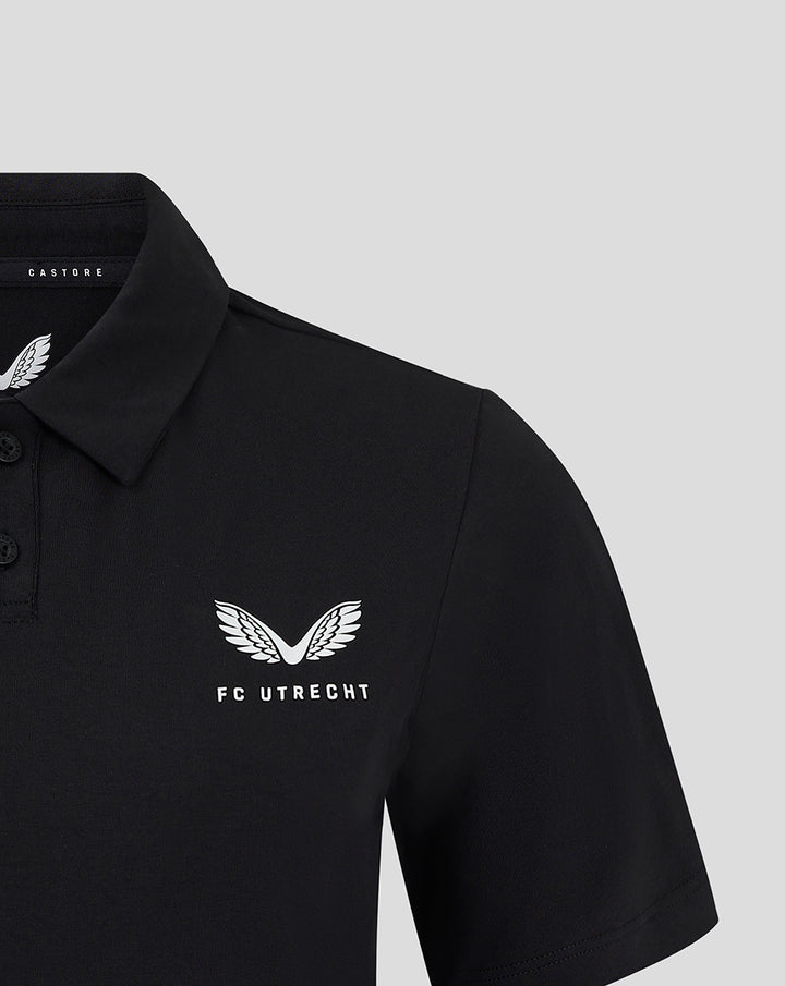 Front left chest view of black FC Utrecht Travel Polo for women featuring the white FC Utrecht wing logo