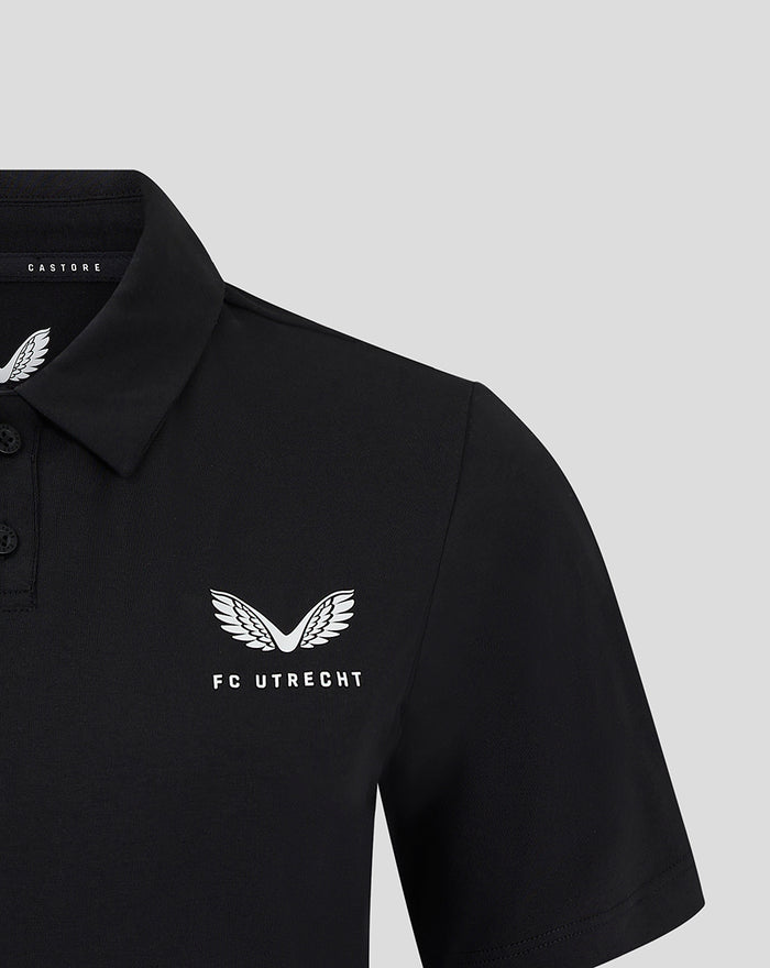 Front left chest view of black FC Utrecht Travel Polo for women featuring the white FC Utrecht wing logo