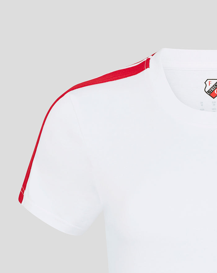 Shoulder and neckline close up with red stripe and crest patch on white women's T-shirt.