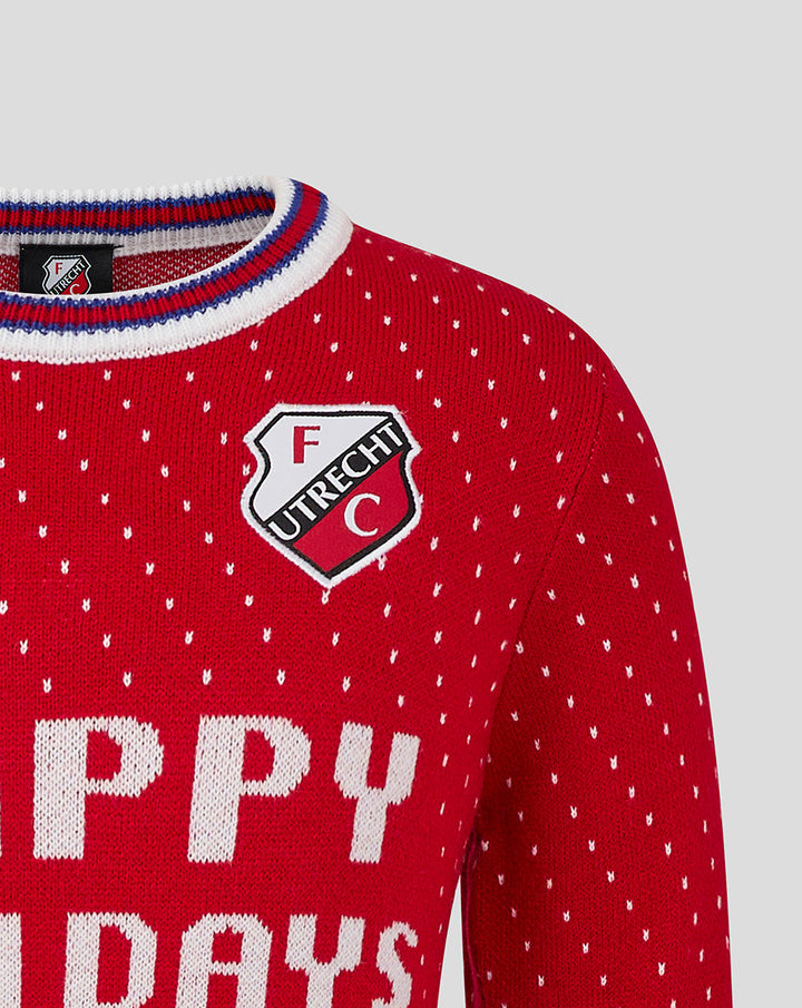 Close-up of red knit FC Utrecht Christmas sweater with crest on the chest and tiny white dots.