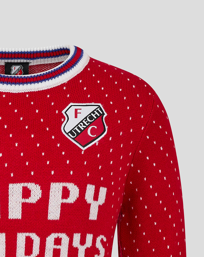Close-up of red knit FC Utrecht Christmas sweater with crest on the chest and tiny white dots.