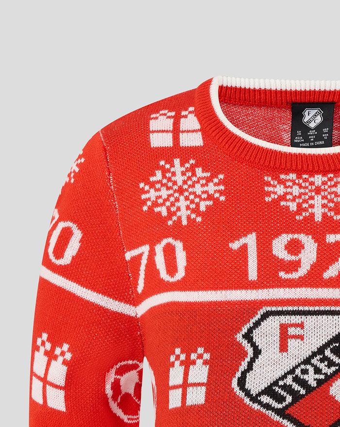 Close up of the neckline and shoulder of the red FC Utrecht junior Christmas sweater showing knitted pattern and crest