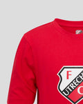 Close up of red FC Utrecht junior T-shirt neckline with partial crest at the collar.