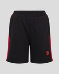 Black junior shorts with red side stripes and a crest patch at the bottom