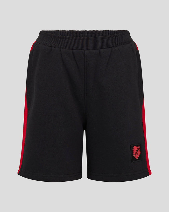 Black junior shorts with red side stripes and a crest patch at the bottom