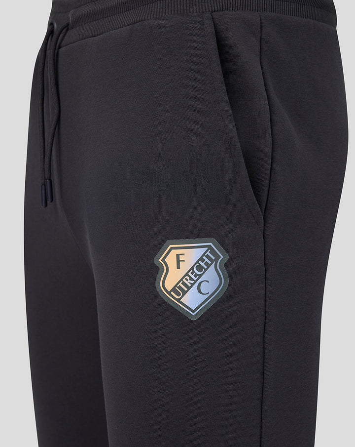 Close up of black FC Utrecht lifestyle jogging pants with crest patch on the thigh
