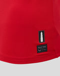 Red fabric at the hem with Castore logo patch and a serial tag