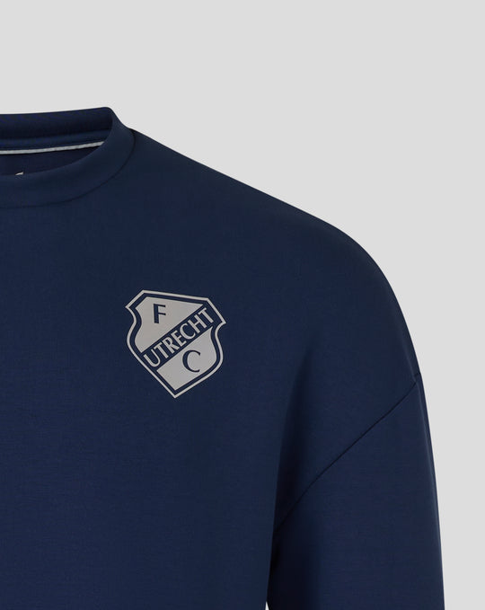 Close up of navy FC Utrecht Travel Sweater showing the crewneck and FC Utrecht crest on the chest.