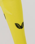 Bright yellow goalkeeper sock with black crest emblem near the calf