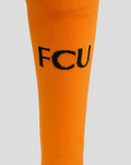 Orange FC Utrecht keeper sock close-up displaying the FCU initials across the fabric