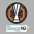 Black circular Europa League badge with white trophy silhouette and UEFA Foundation for Children 10 years logo.