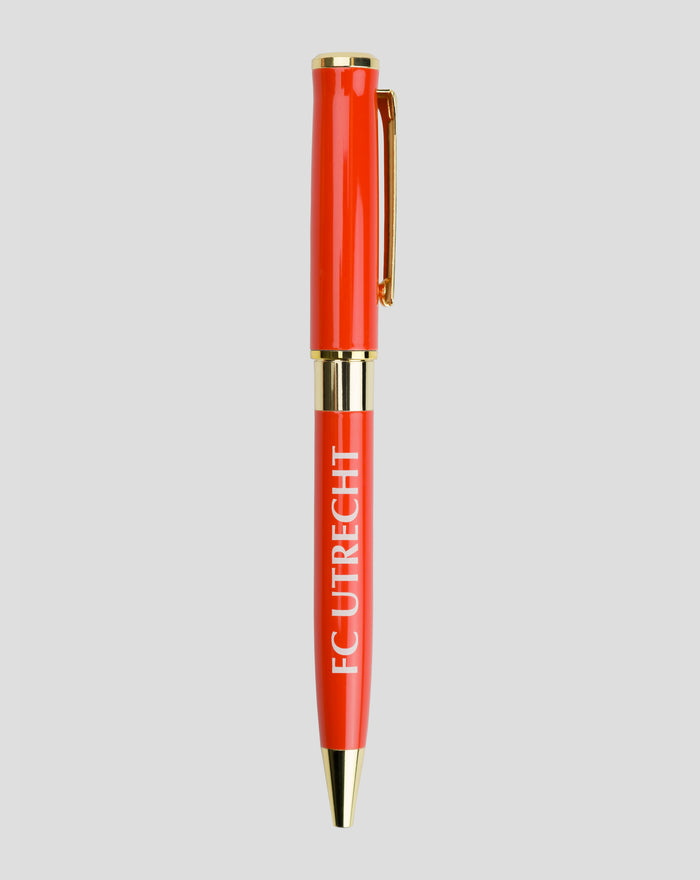 Close up side view of red FC Utrecht pen with gold trim and clip