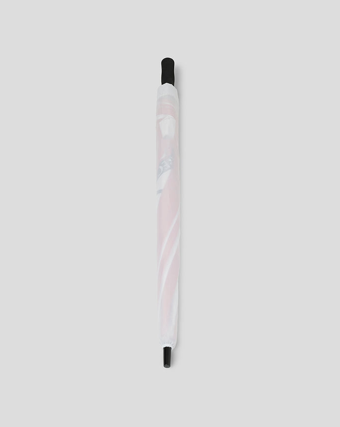 Colorful twisted golf umbrella wrapped in a white protective sleeve with black end caps