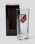 Clear FC Utrecht longdrink glass with crest on the front beside a black packaging box.