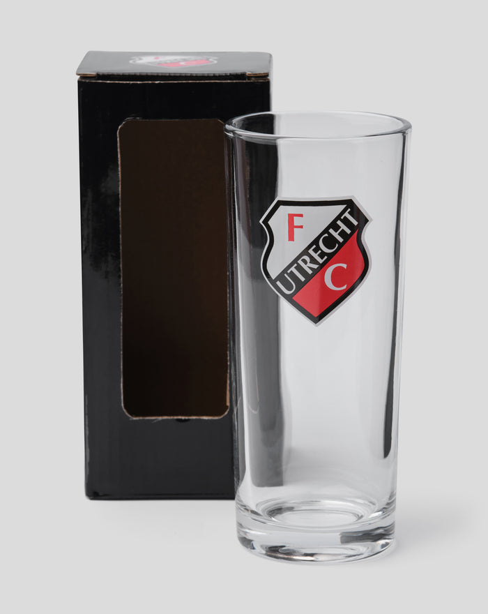 Clear FC Utrecht longdrink glass with crest on the front beside a black packaging box.