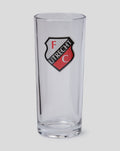 Close up FC Utrecht longdrink glass with crest visible on the front and packaging in background.
