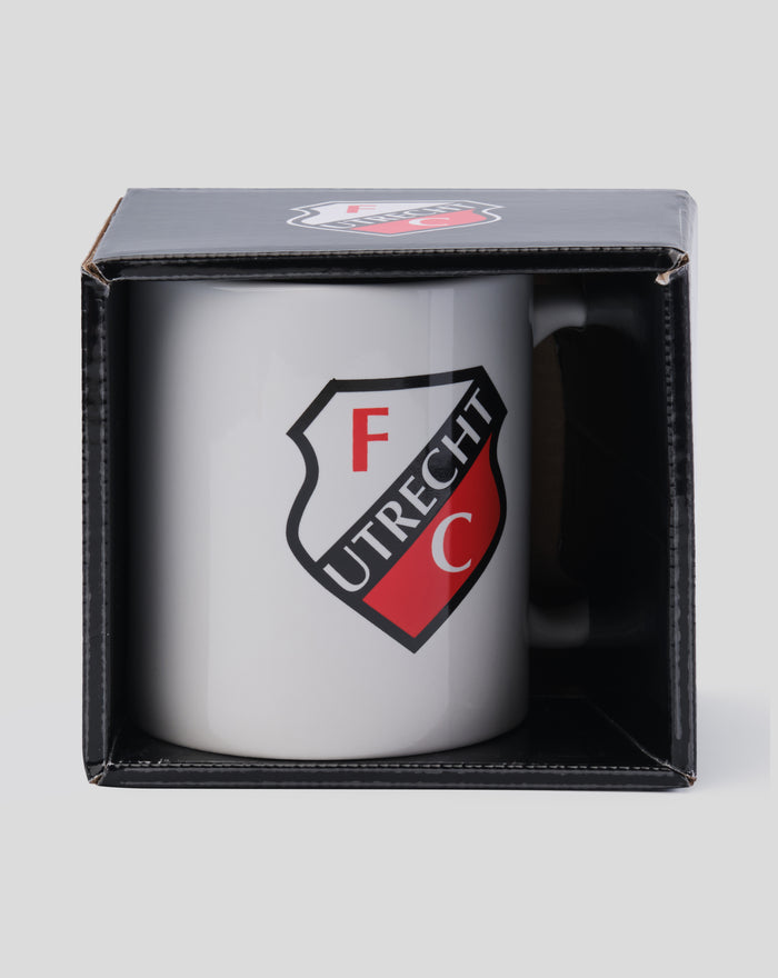 White FC Utrecht mug with crest in front of a closed black box with lid displaying the crest logo