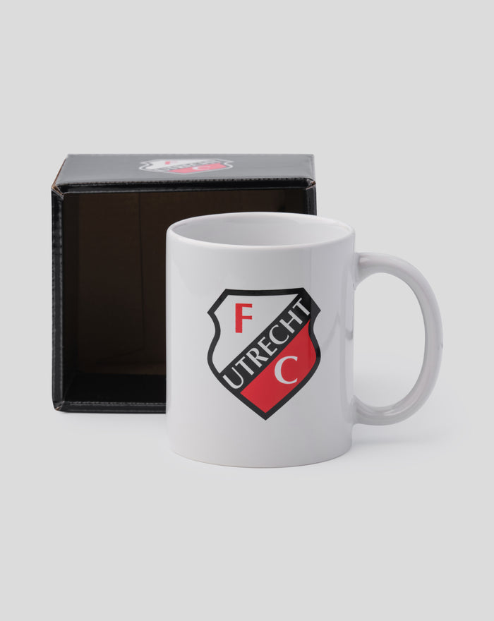White FC Utrecht mug with crest visible beside an open black gift box on a light gray background