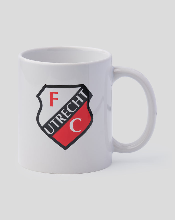 White FC Utrecht mug with crest angled beside an open black box with the handle visible
