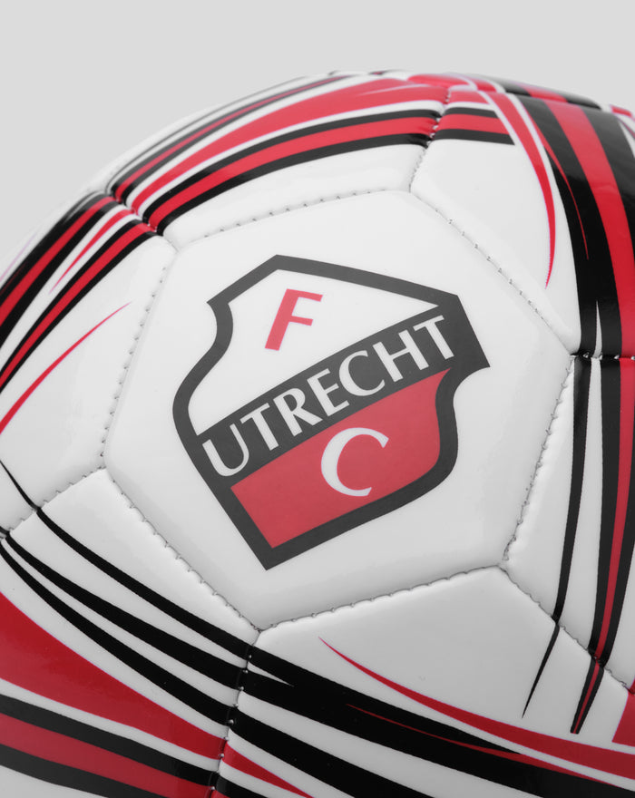 Close up of FC Utrecht crest on a white soccer ball with red and black stripes