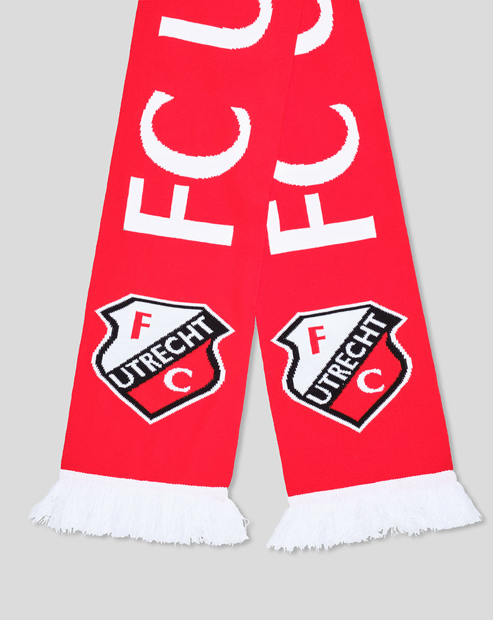 Close up of red FC Utrecht scarf showing bold white UTRECHT letters and crest near the ends, white fringe.