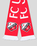 Close up of red FC Utrecht scarf showing bold white UTRECHT letters and crest near the ends, white fringe.